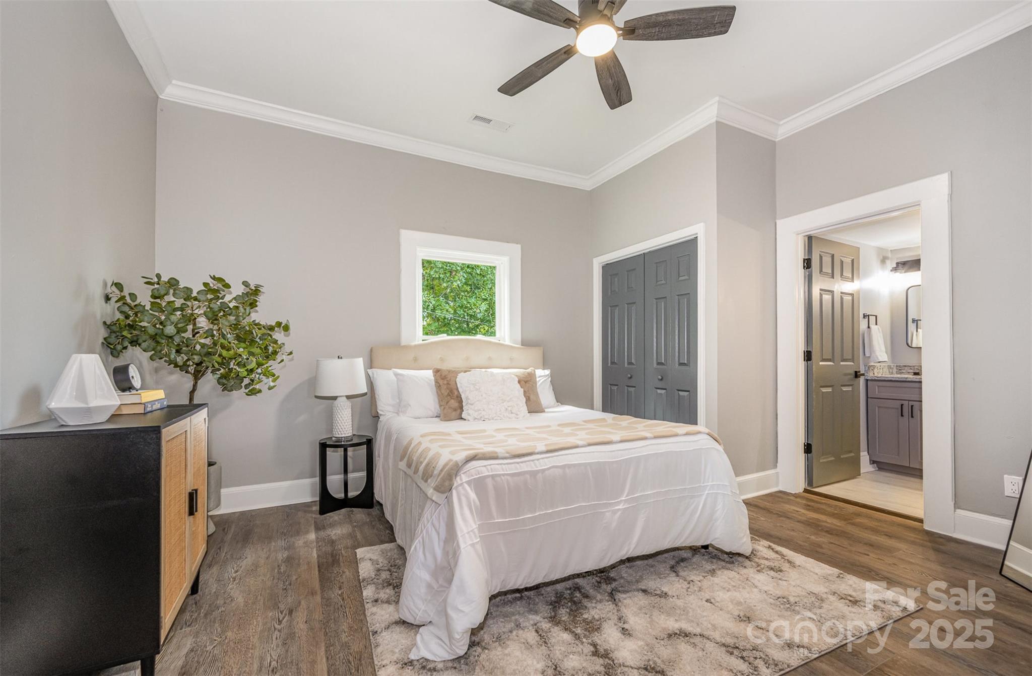201 Valley Street Stanley, NC 28164 - Photo 11 of 25 a bedroom with a large bed and a chandelier