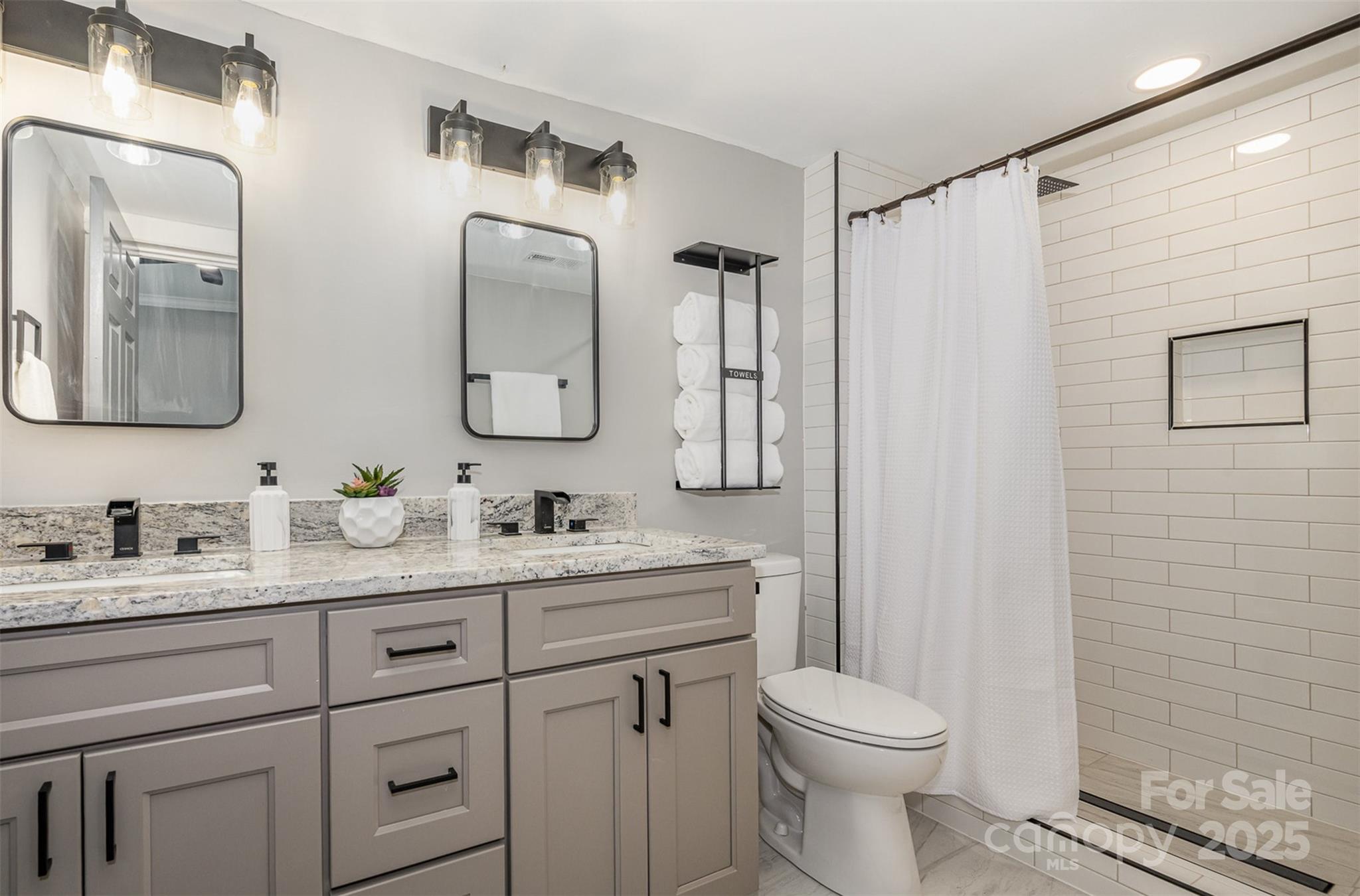 201 Valley Street Stanley, NC 28164 - Photo 11 of 25 a bathroom with a toilet sink and mirror