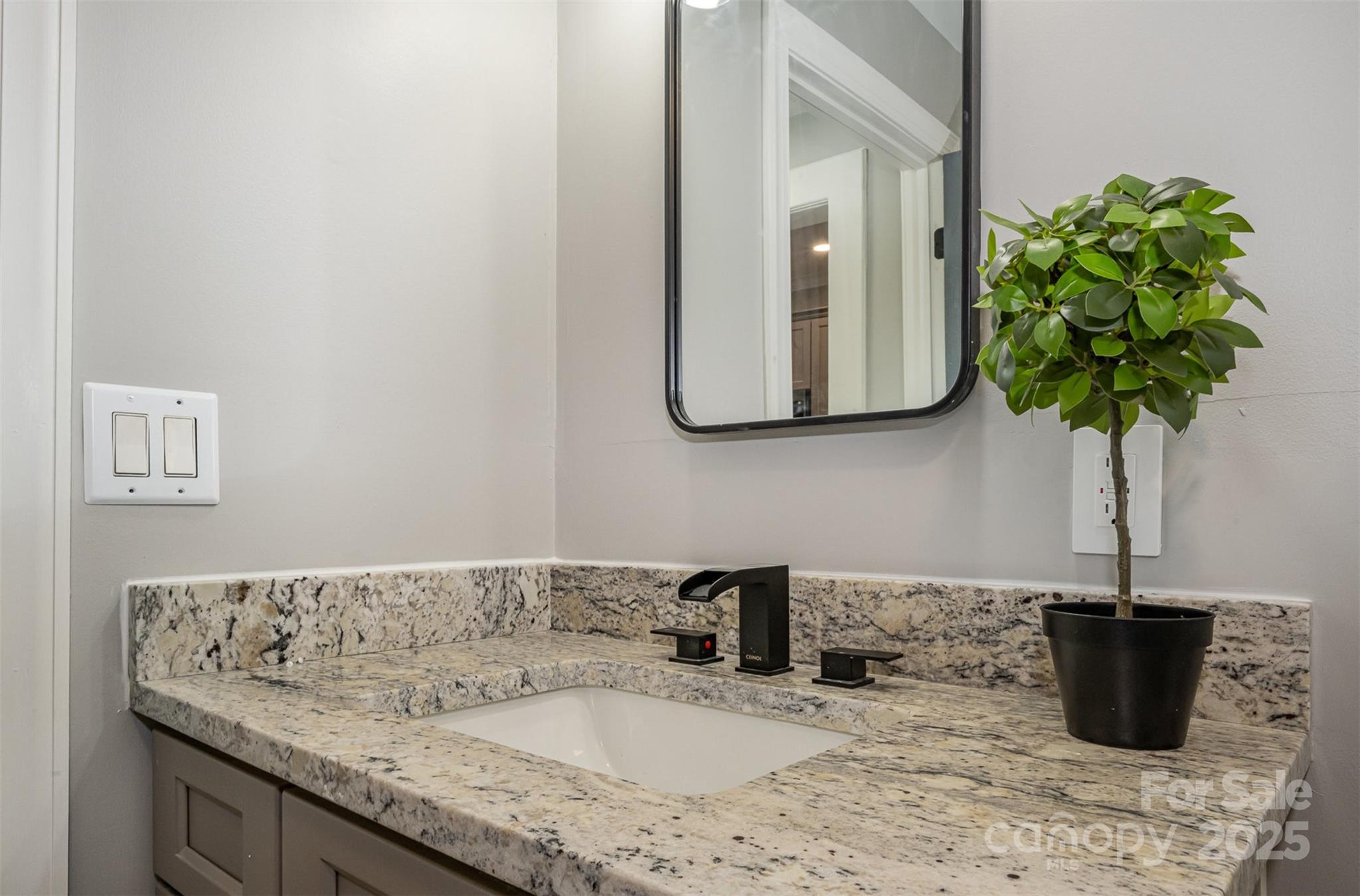 201 Valley Street Stanley, NC 28164 - Photo 14 of 25 a bathroom with a granite countertop sink a mirror and vanity