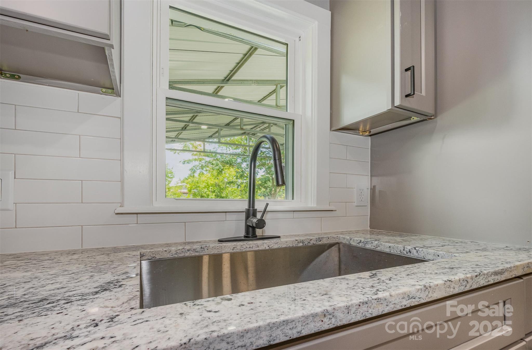 201 Valley Street Stanley, NC 28164 - Photo 4 of 25 a kitchen with a granite countertop sink and window