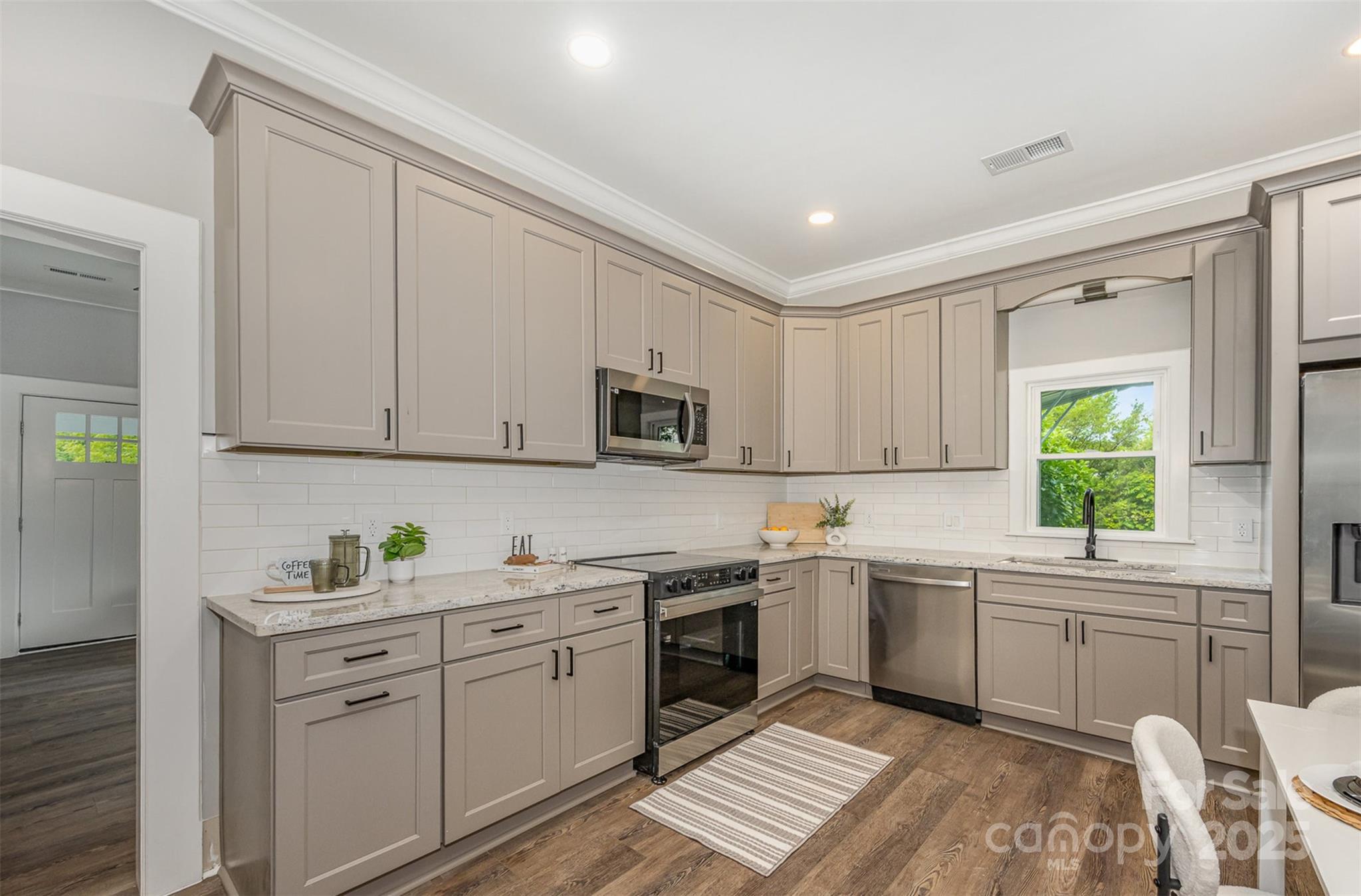 201 Valley Street Stanley, NC 28164 - Photo 4 of 25 a kitchen with a sink window and cabinets