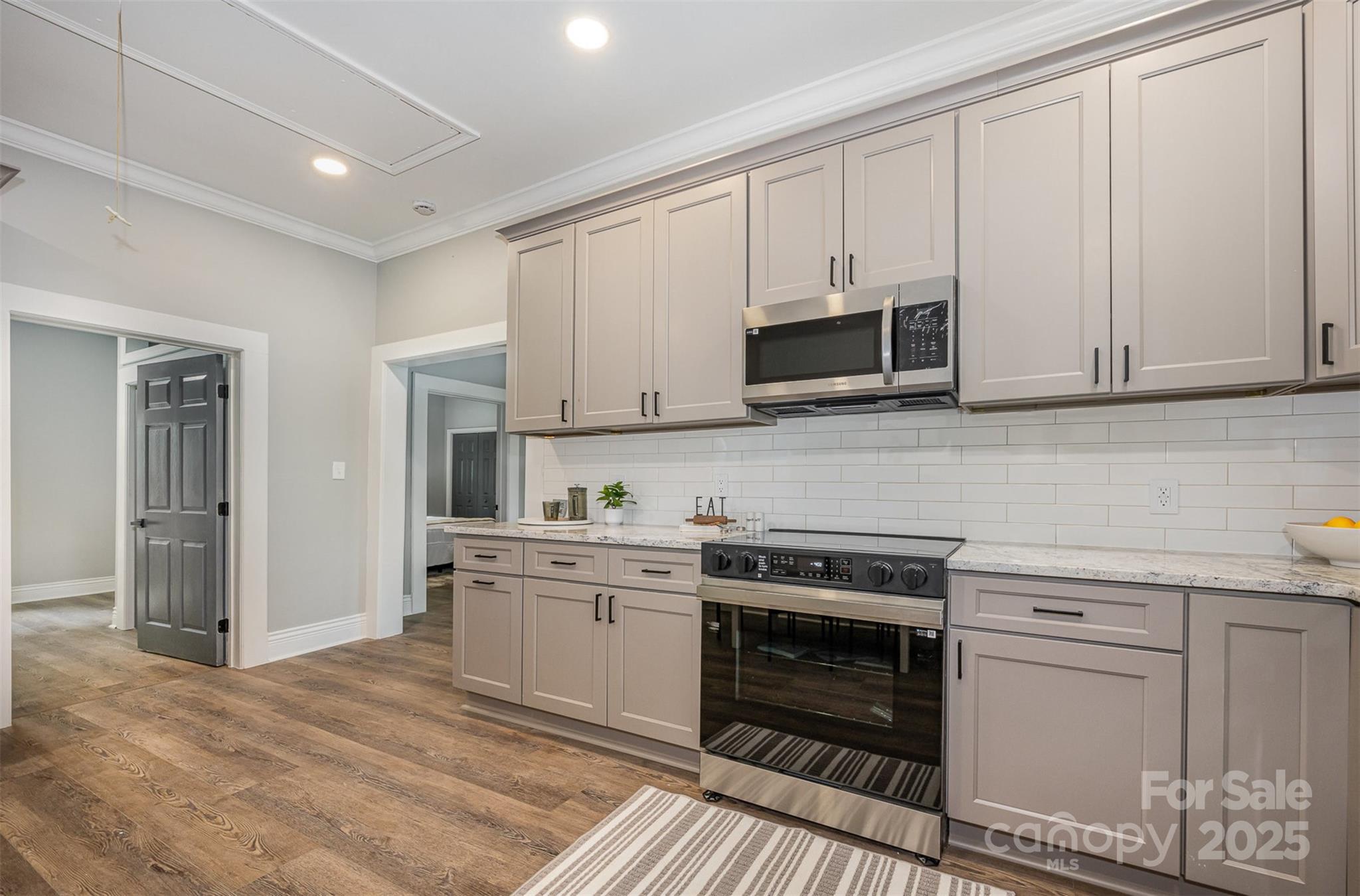 201 Valley Street Stanley, NC 28164 - Photo 5 of 25 a kitchen with stainless steel appliances granite countertop a stove and a sink