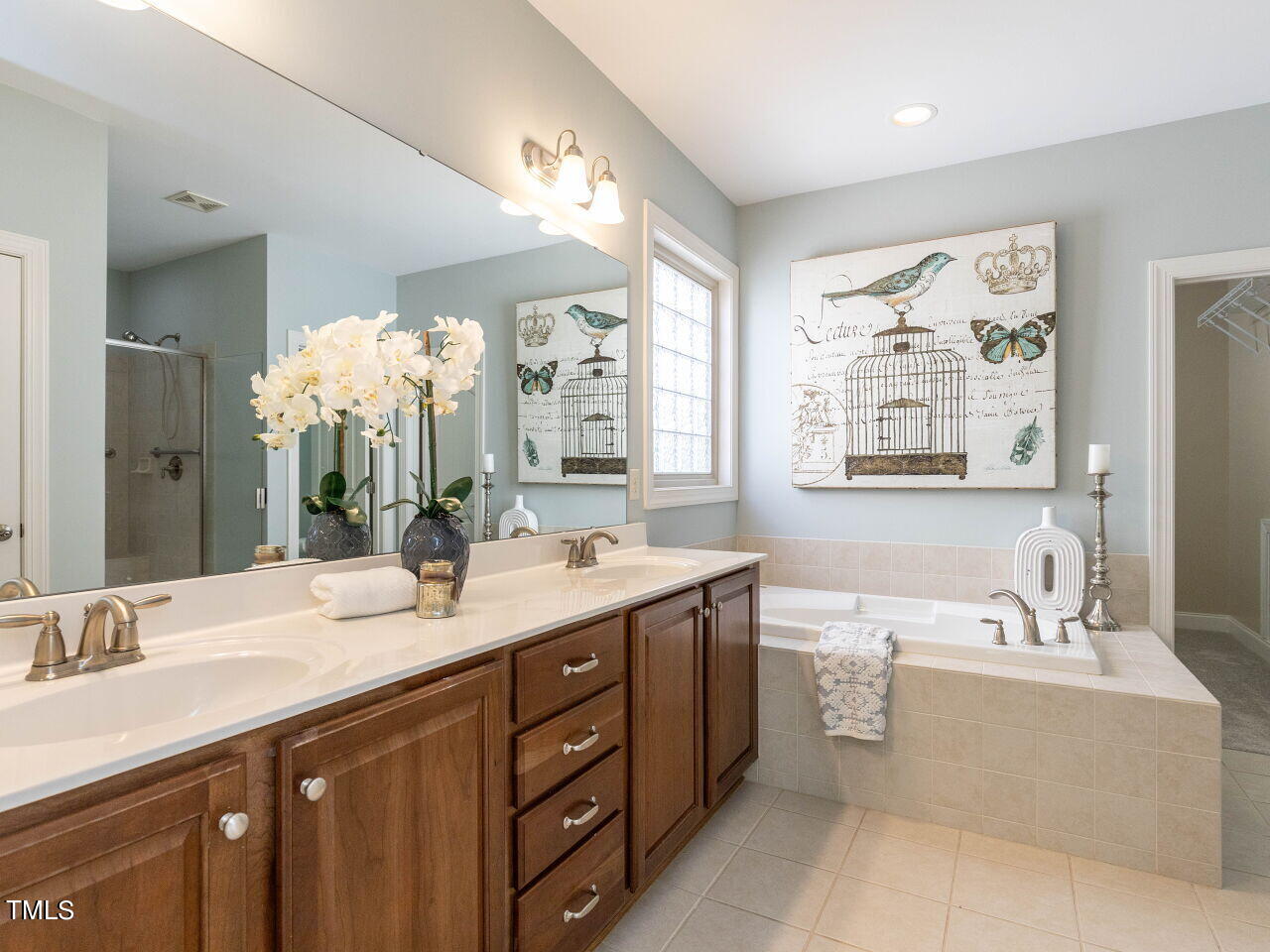 1805 Stonebanks Loop Cary, NC 27518 - Photo 14 of 27 a bathroom with a tub double sink mirror and