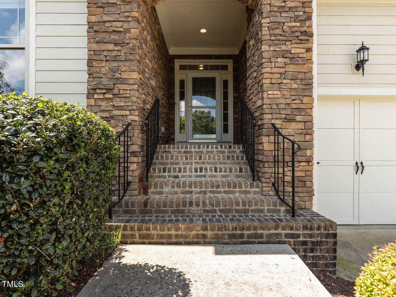 1805 Stonebanks Loop Cary, NC 27518 - Photo 2 of 27 a view of a brick house with large windows