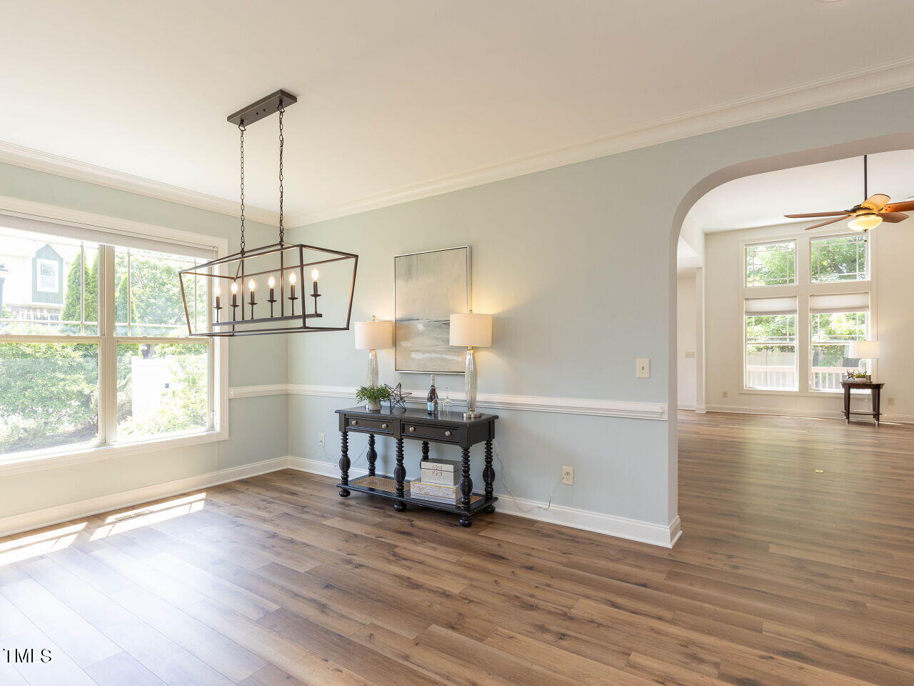1805 Stonebanks Loop Cary, NC 27518 - Photo 5 of 27 a view of a dining room and livingroom with furniture wooden floor a chandelier