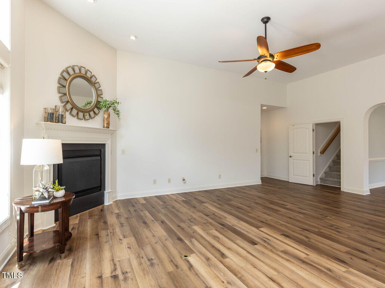1805 Stonebanks Loop Cary, NC 27518 - Photo 9 of 27 a view of empty room with wooden floor and fan