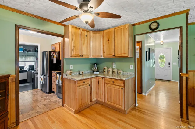 a kitchen with stainless steel appliances granite countertop a refrigerator and a sink