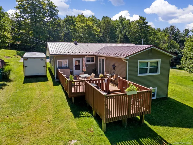 a roof deck with table and chairs