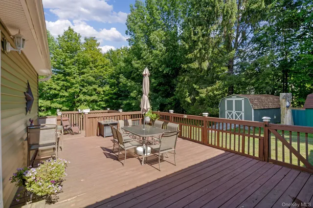 a view of a patio with table and chairs and wooden floor