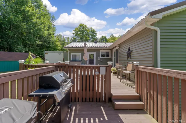 a view of a deck with a table and chairs with wooden floor and fence