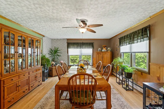 a view of a dining room with furniture window and wooden floor