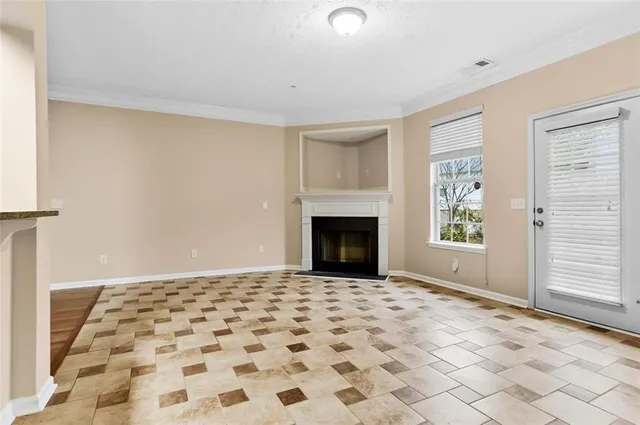 a big room with windows and fireplace