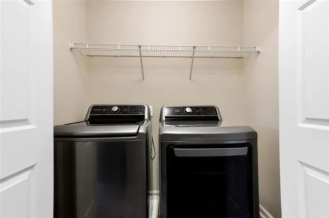 a view of storage and utility room with washer and dryer