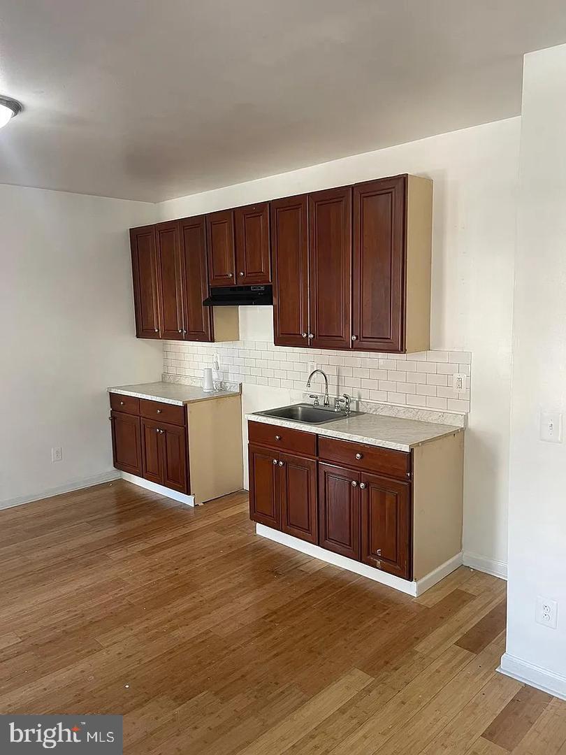5835 Arch Street Philadelphia, PA 19139 - Photo 2 of 21 a kitchen with stainless steel appliances granite countertop a sink a stove a microwave a sink and a refrigerator