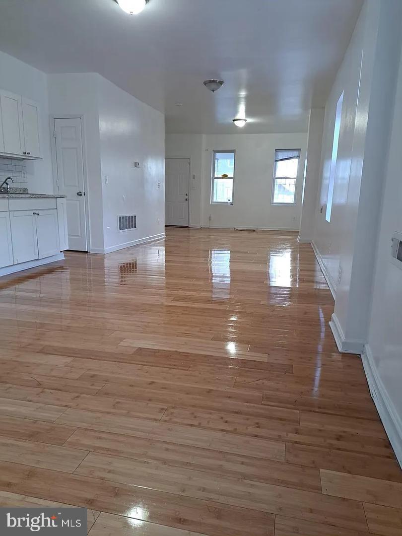 5835 Arch Street Philadelphia, PA 19139 - Photo 7 of 21 a view of empty room with wooden floor and window