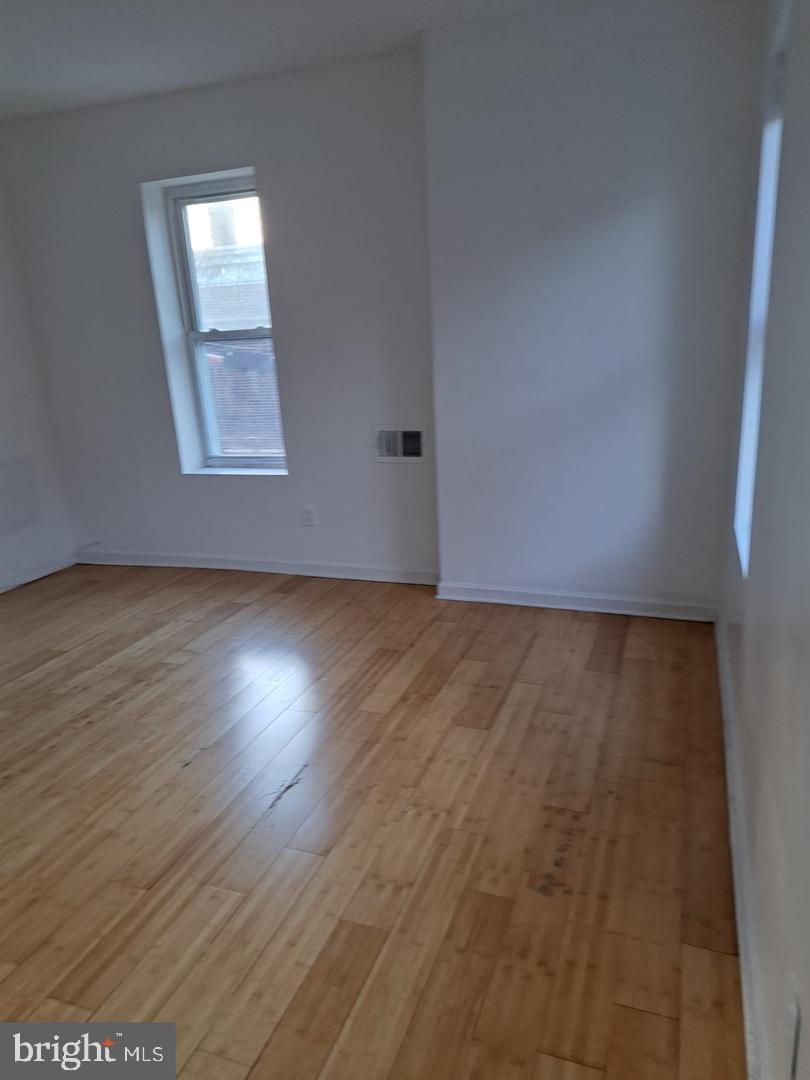 5835 Arch Street Philadelphia, PA 19139 - Photo 8 of 21 an empty room with wooden floor and windows