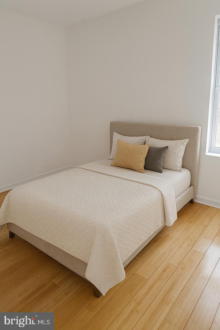 5835 Arch Street Philadelphia, PA 19139 - Photo 9 of 21 a large bed sitting in a bedroom next to a window
