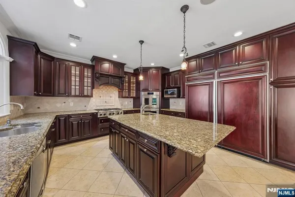 a bathroom with a granite countertop shower a toilet and a sink