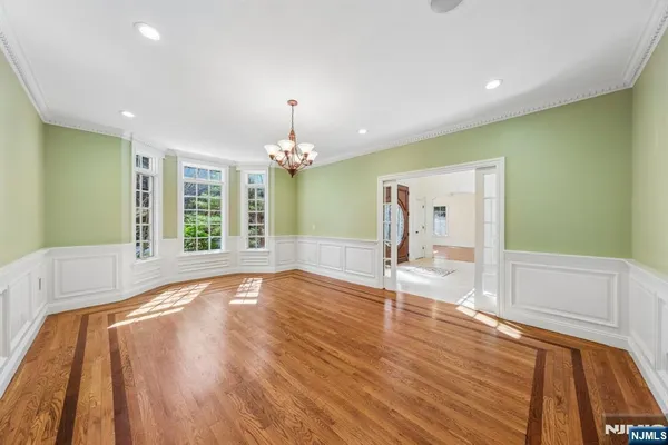 a view of empty room with wooden floor and fireplace