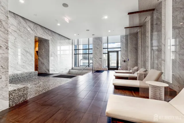 a living room with patio furniture and a large window