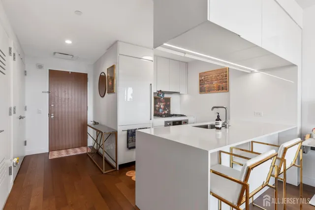 a view of kitchen with sink and wooden floor