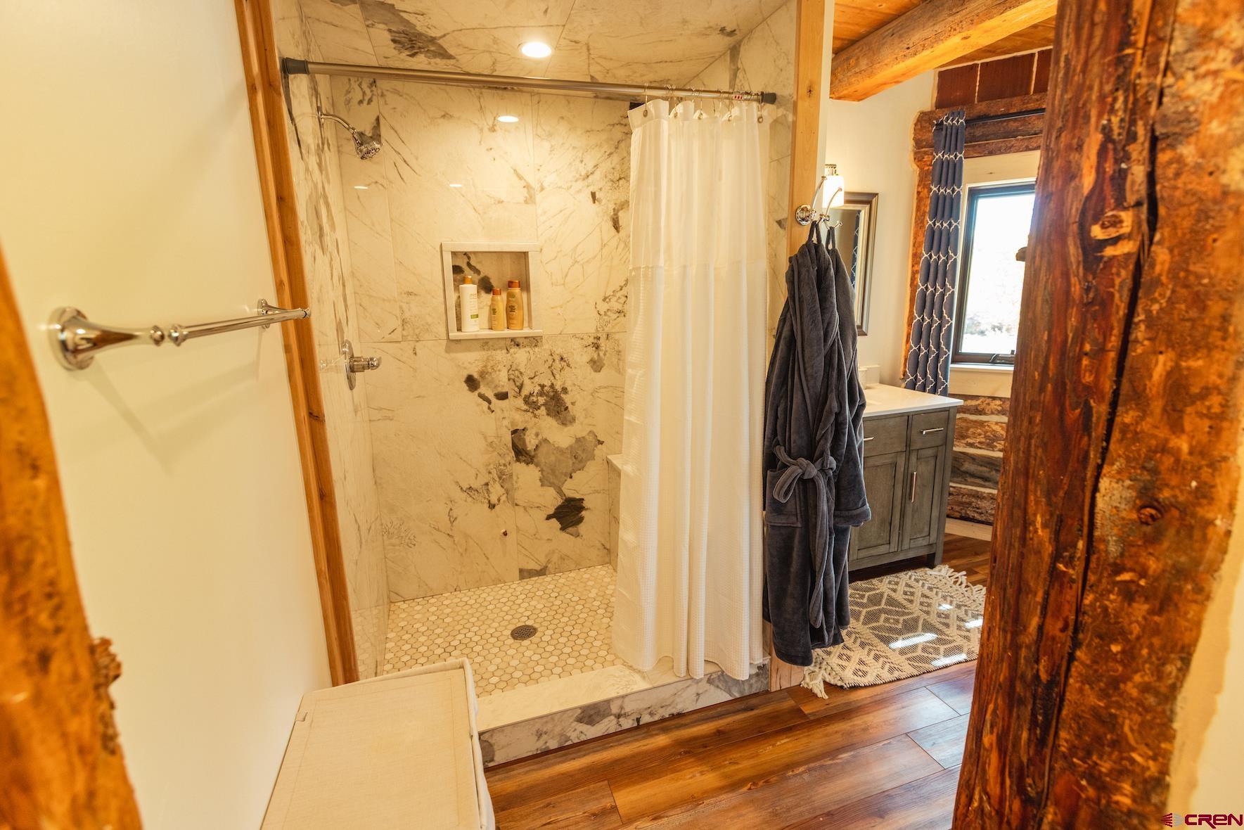 246 Lower Allen Road Crested Butte, CO 81224 - Photo 17 of 26 a bathroom with a shower and a glass door