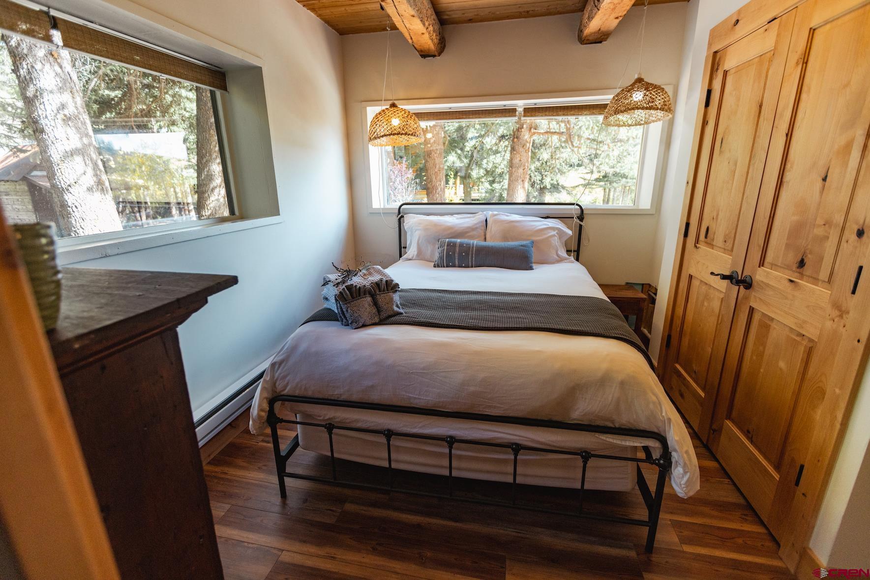 246 Lower Allen Road Crested Butte, CO 81224 - Photo 20 of 26 a bedroom with a bed and a window