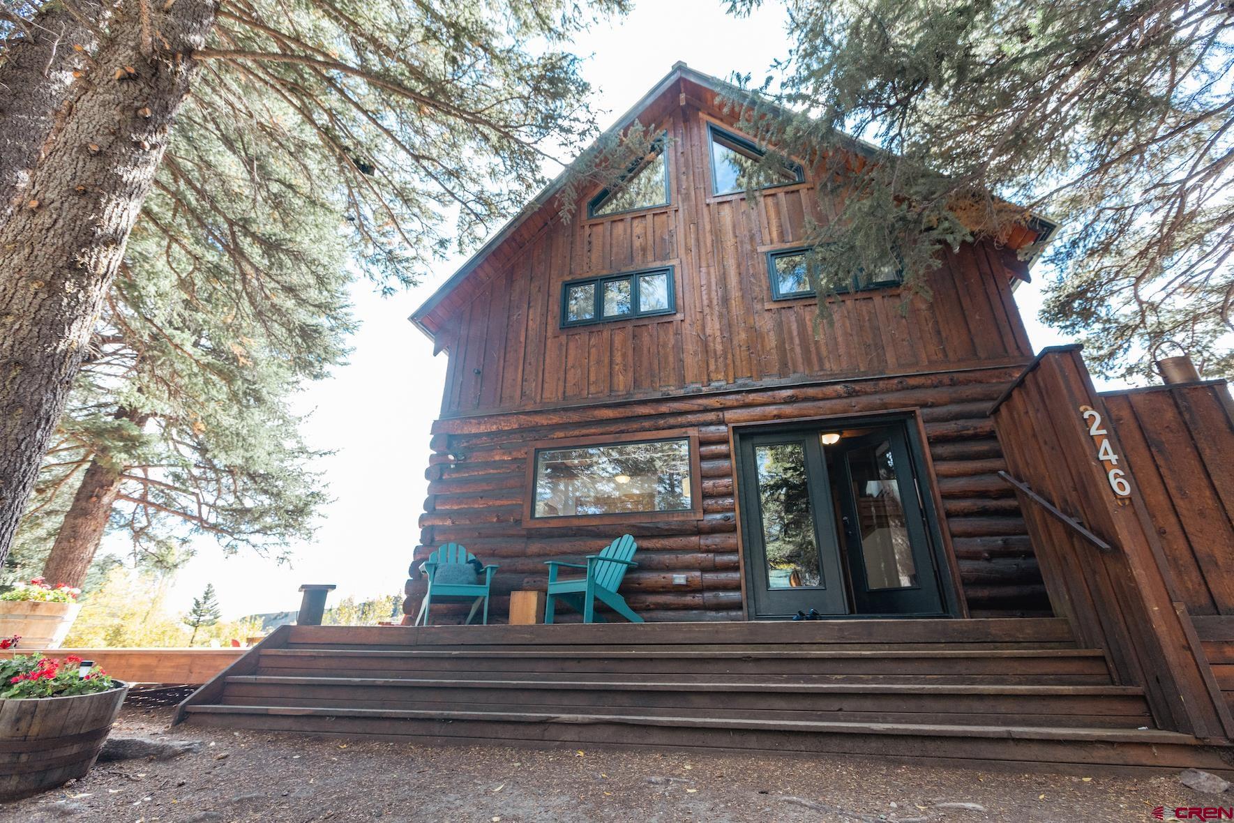 246 Lower Allen Road Crested Butte, CO 81224 - Photo 4 of 26 a view of a house with large windows and wooden fence