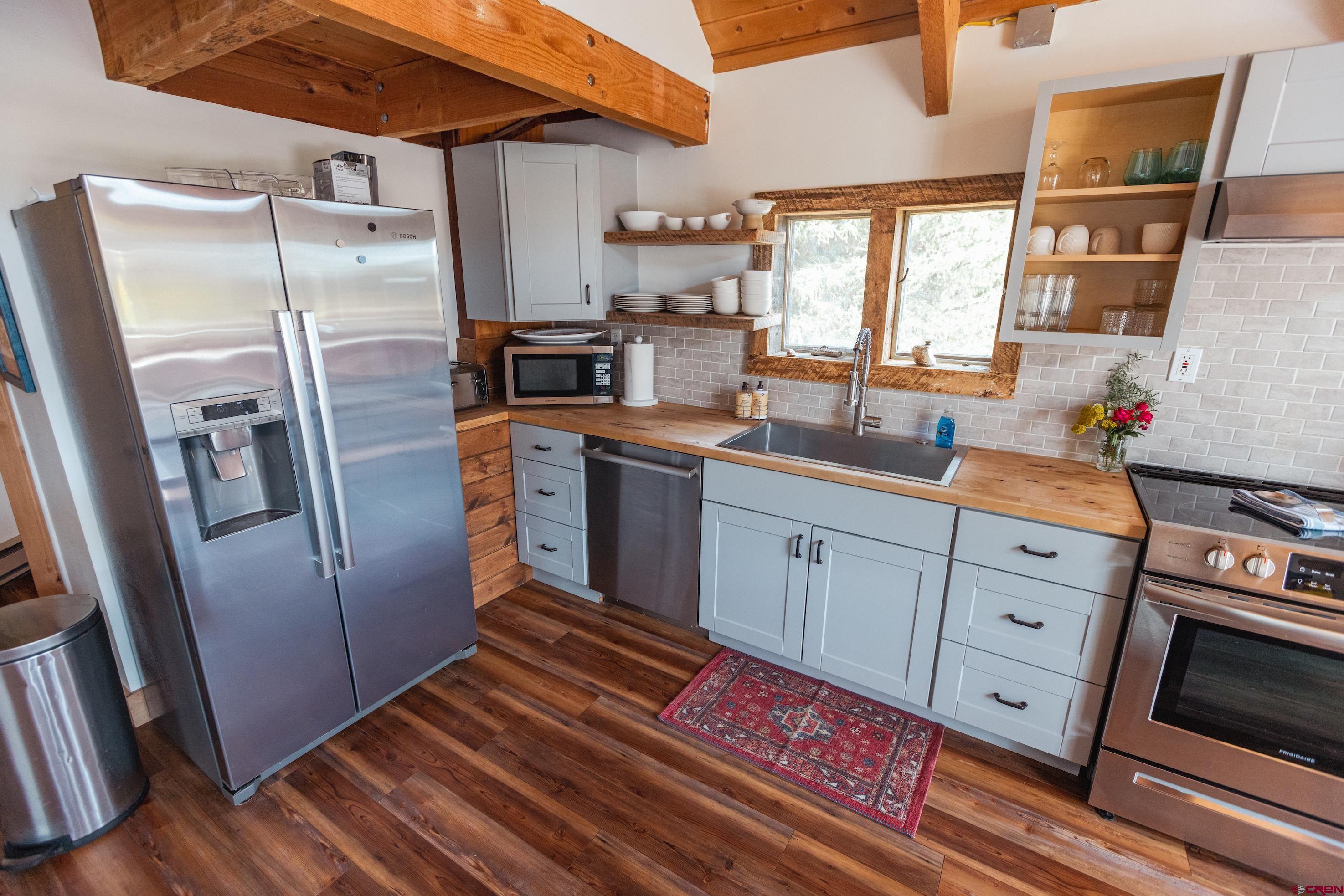 246 Lower Allen Road Crested Butte, CO 81224 - Photo 8 of 26 a kitchen with stainless steel appliances a refrigerator sink and microwave
