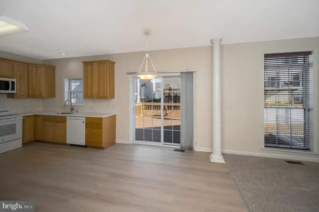 a large kitchen with a large window and a sink