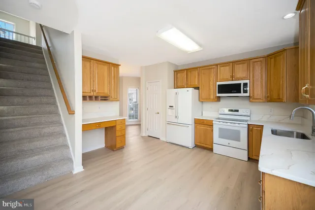 a kitchen with a refrigerator stove and sink