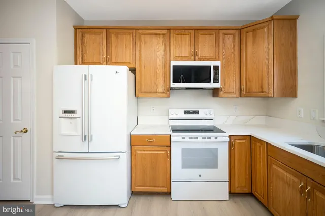 a kitchen with a stove a sink and a refrigerator