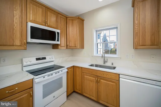 a kitchen with a sink stove and microwave