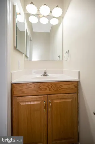 a bathroom with a sink vanity and a mirror