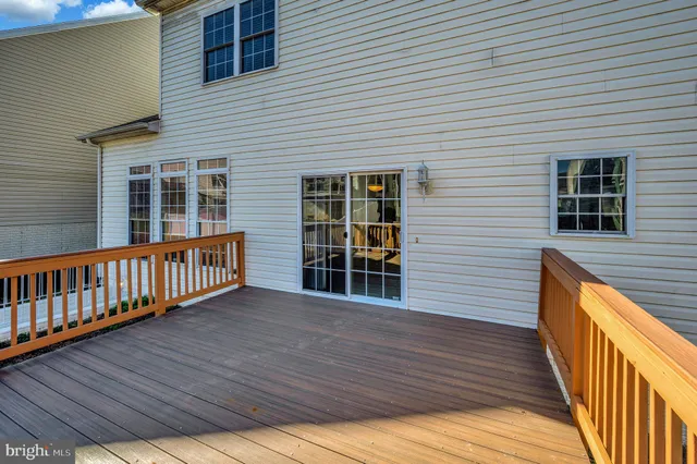 a view of a house with wooden deck