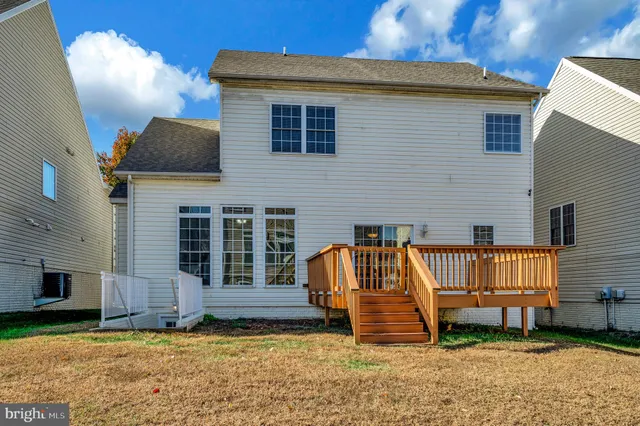 a view of a house with backyard and porch