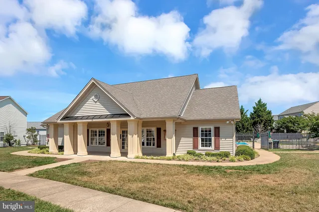 a front view of a house with a yard table and chairs