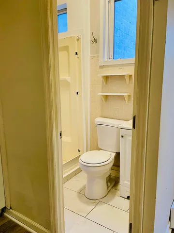 a bathroom with a toilet and a shower