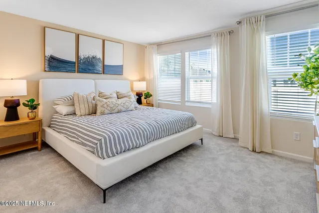 a bedroom with a bed and glass window