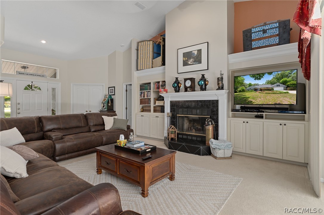 2460 West Pine Ridge Boulevard Beverly Hills, FL 34465 - Photo 24 of 47 a living room with furniture and a fireplace