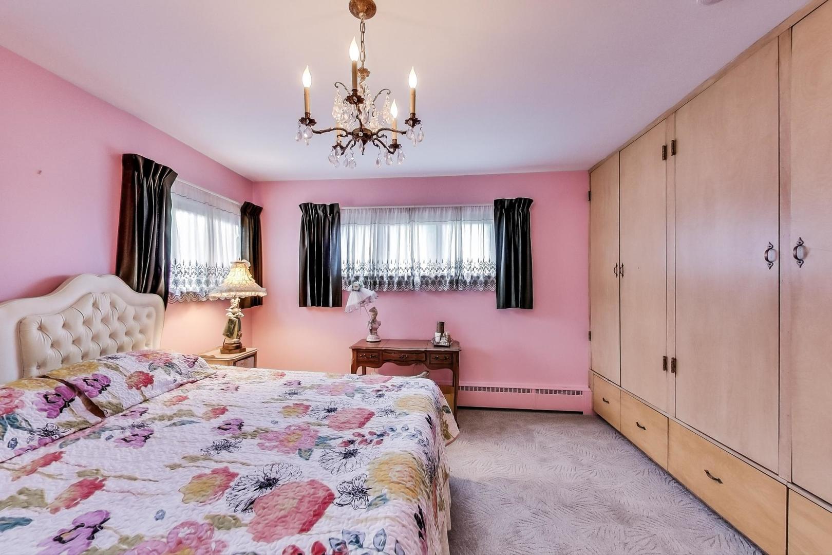 365 Lionel Road Riverside, IL 60546 - Photo 11 of 35 a bedroom with a large bed and a chandelier