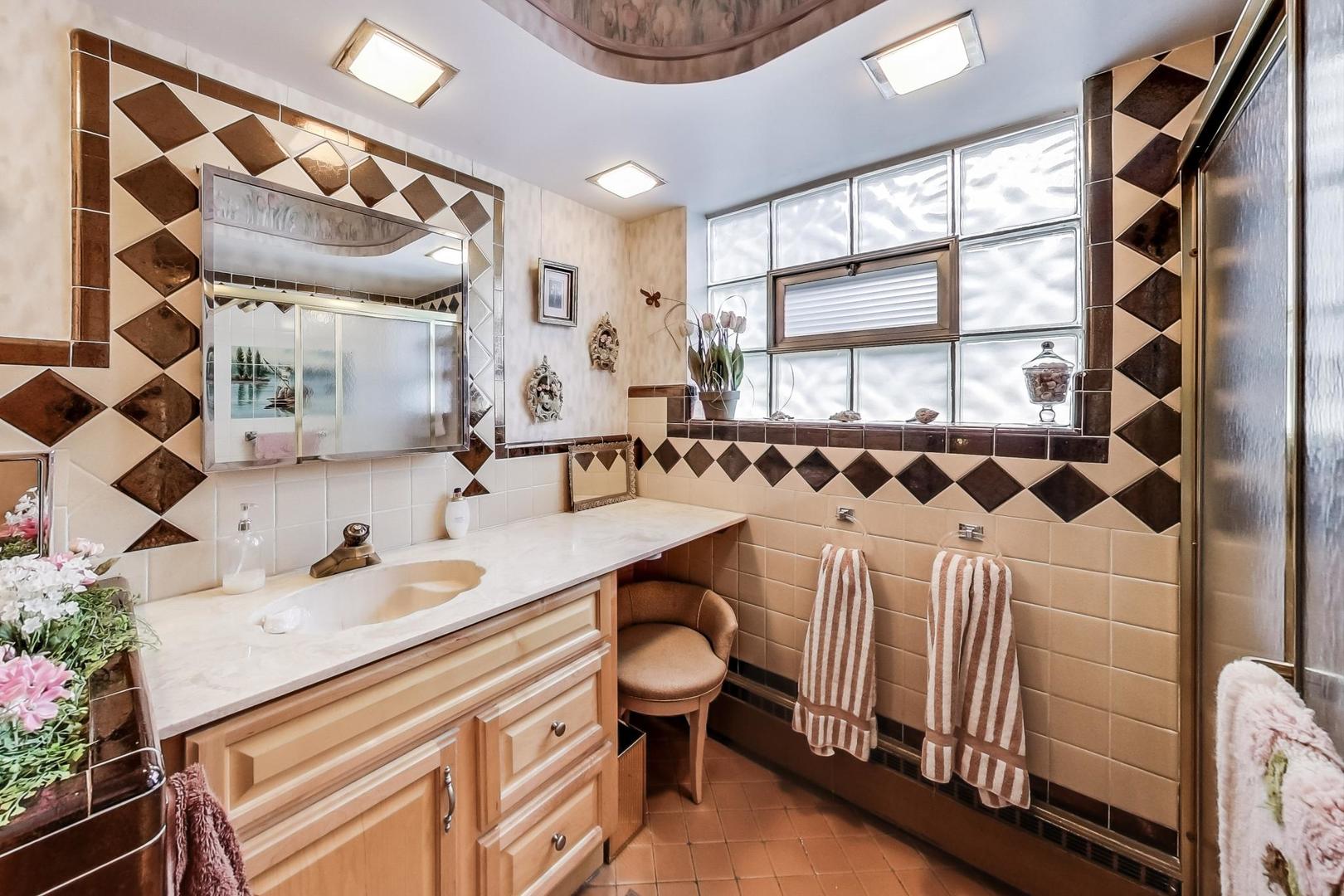 365 Lionel Road Riverside, IL 60546 - Photo 12 of 35 a bathroom with a sink a toilet and a mirror
