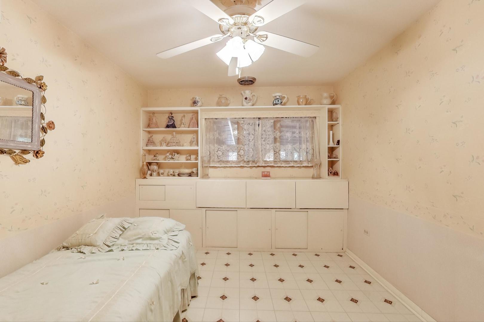 365 Lionel Road Riverside, IL 60546 - Photo 13 of 35 a bedroom with a bed and a chandelier