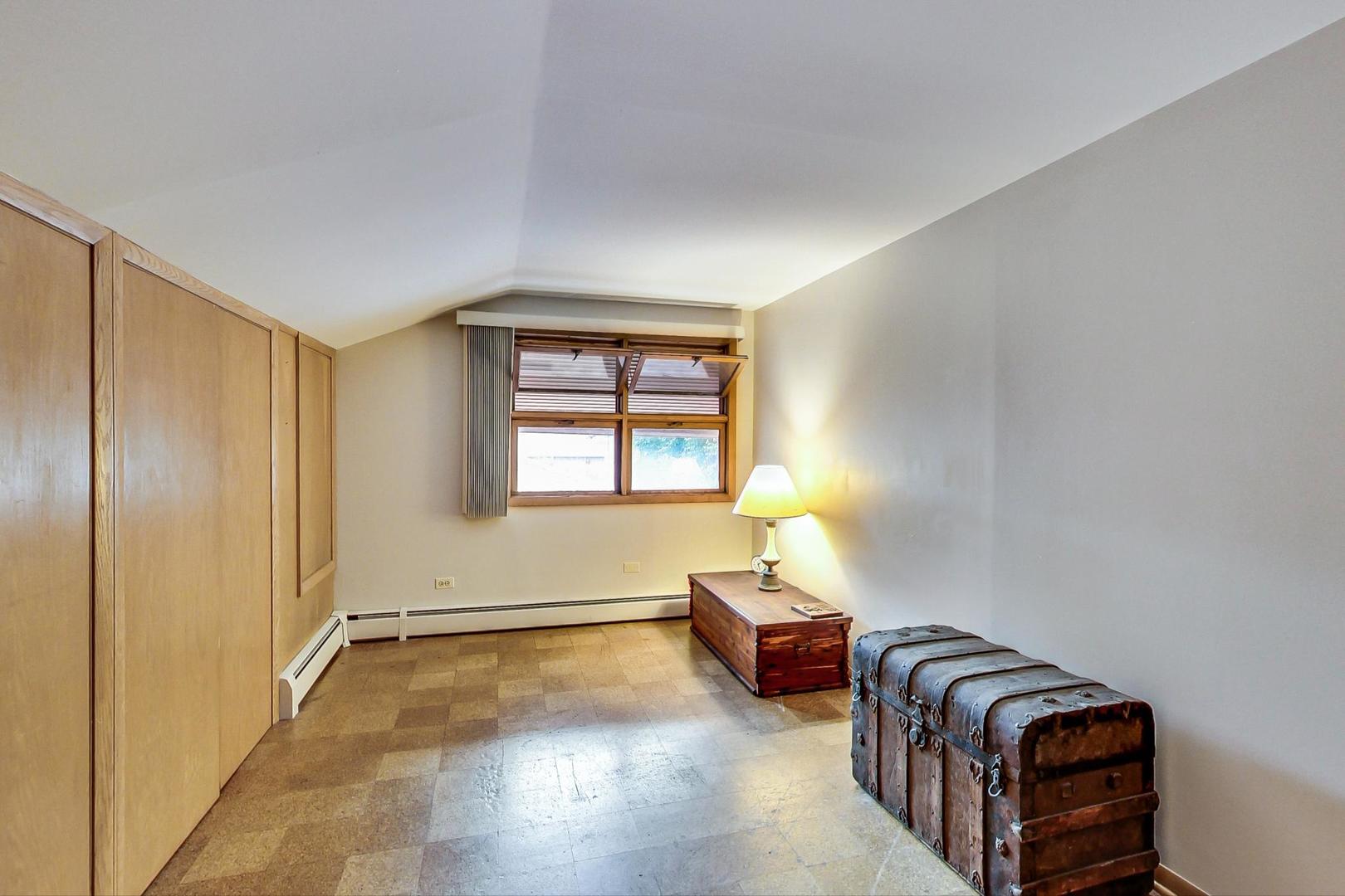 365 Lionel Road Riverside, IL 60546 - Photo 17 of 35 a spacious bedroom with a bed and wooden floor