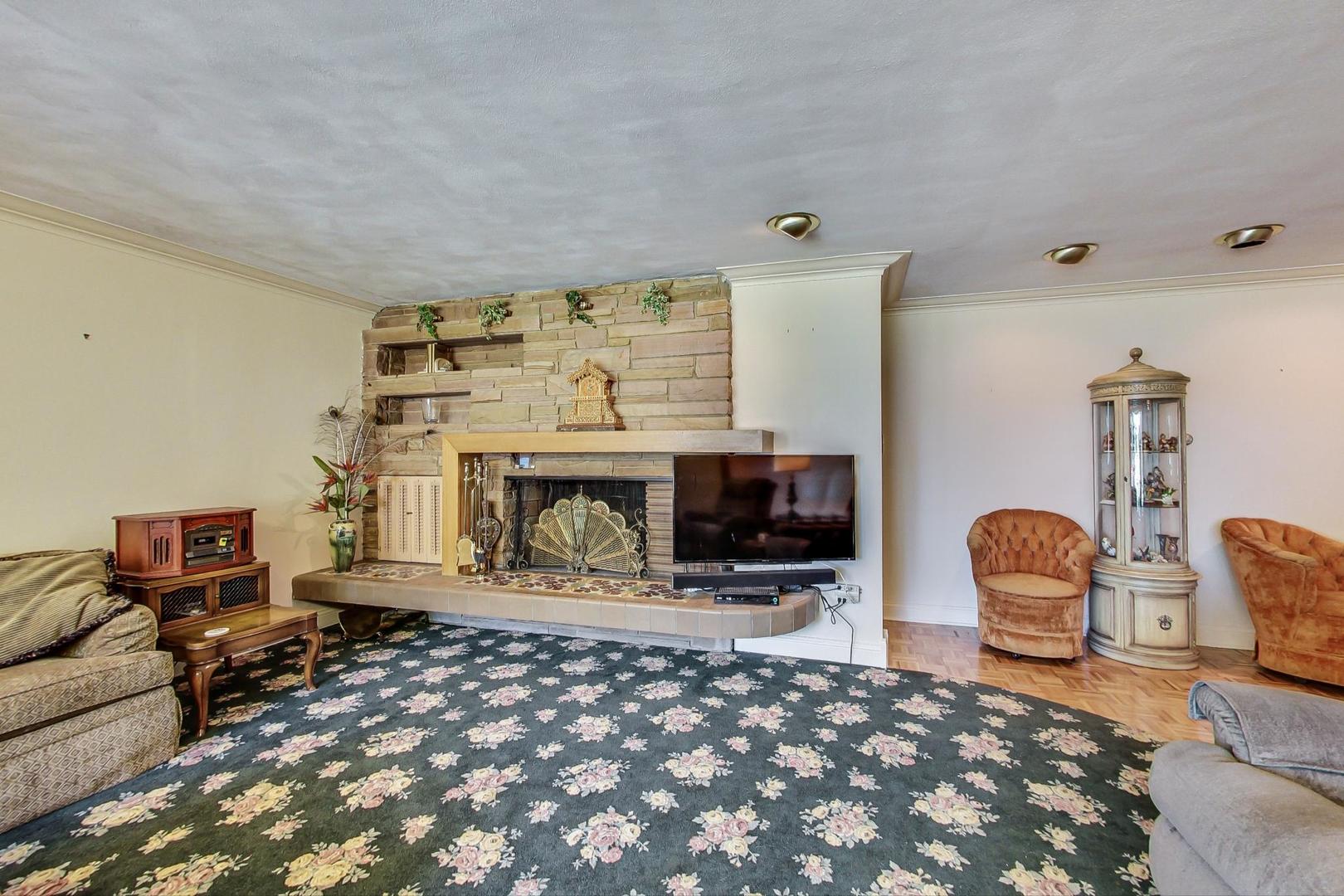 365 Lionel Road Riverside, IL 60546 - Photo 3 of 35 a living room with furniture a fireplace and a table