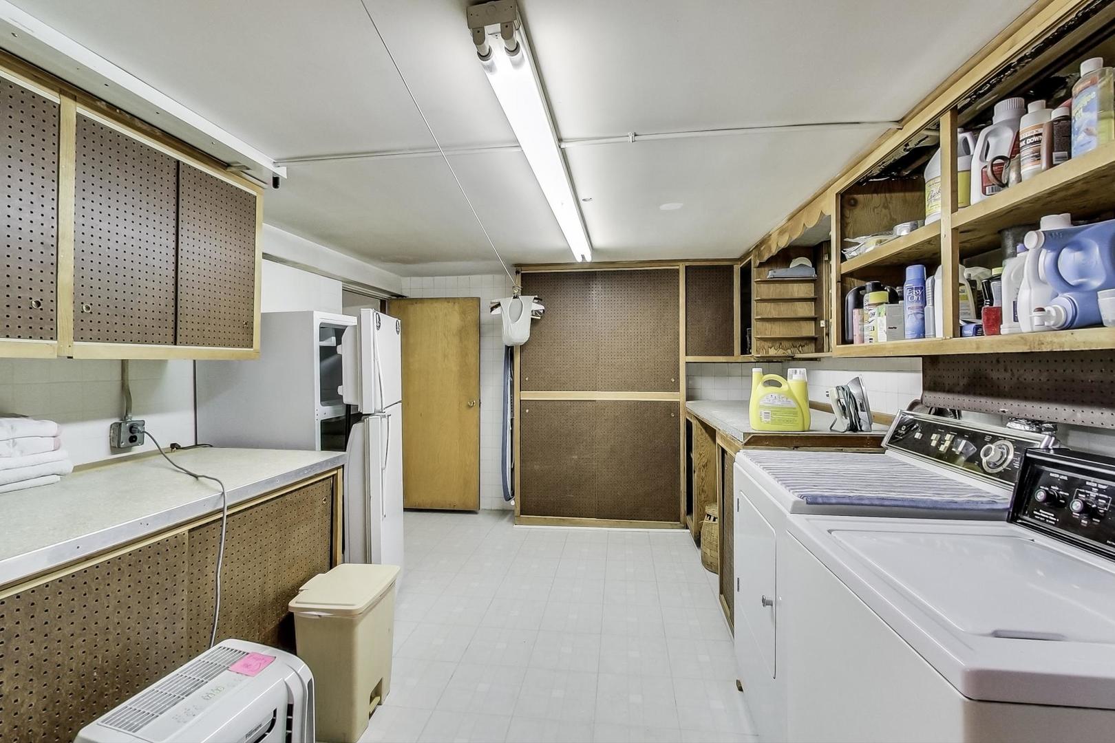 365 Lionel Road Riverside, IL 60546 - Photo 21 of 35 a room with furniture a washer and dryer