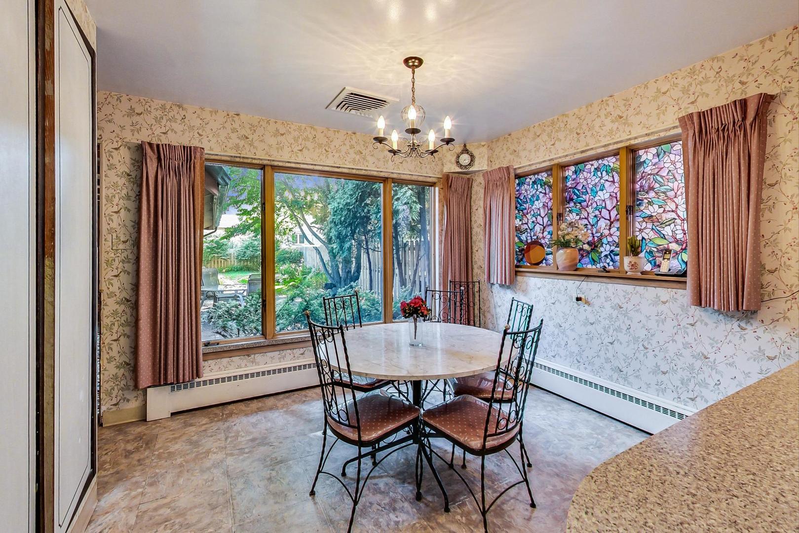 365 Lionel Road Riverside, IL 60546 - Photo 6 of 35 a dining room with furniture a large window and a chandelier