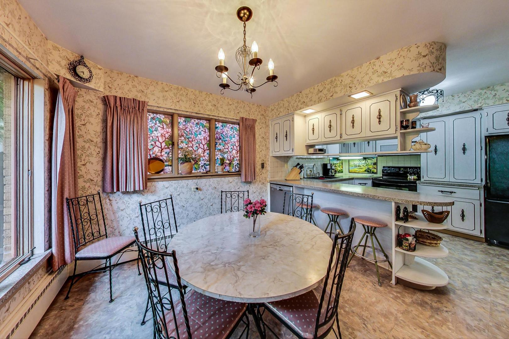 365 Lionel Road Riverside, IL 60546 - Photo 7 of 35 a dining room with furniture a chandelier and window