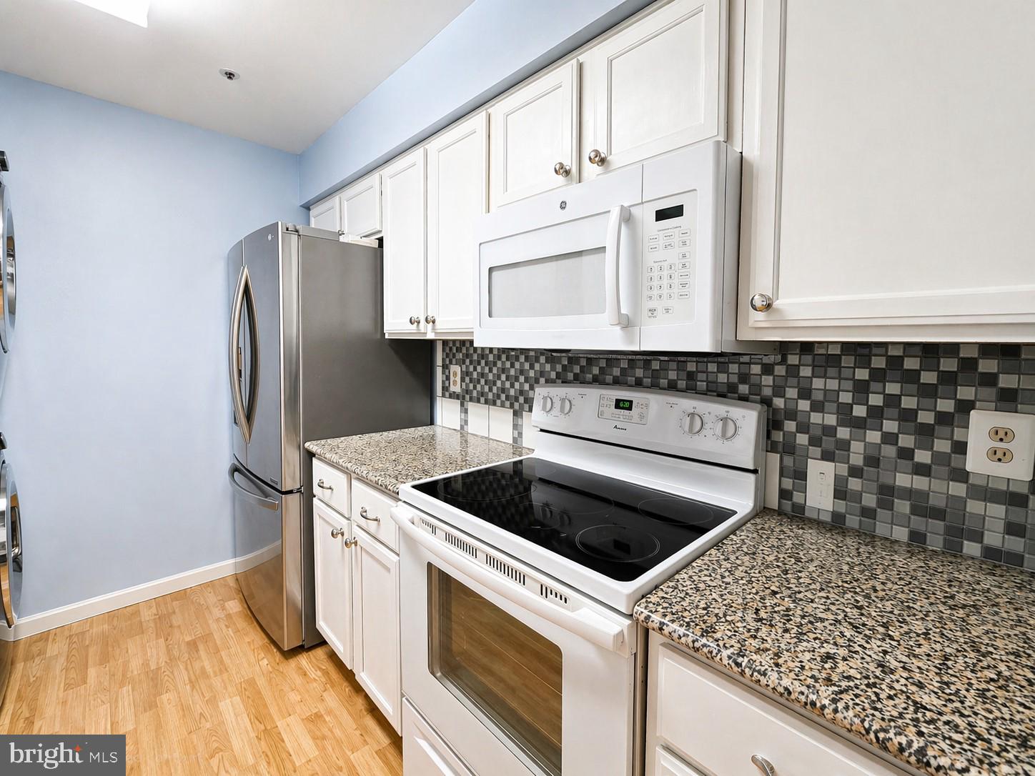 8353 Montgomery Run Road, Unit F Ellicott City, MD 21043 - Photo 10 of 25 a kitchen with stainless steel appliances granite countertop a sink stove and refrigerator