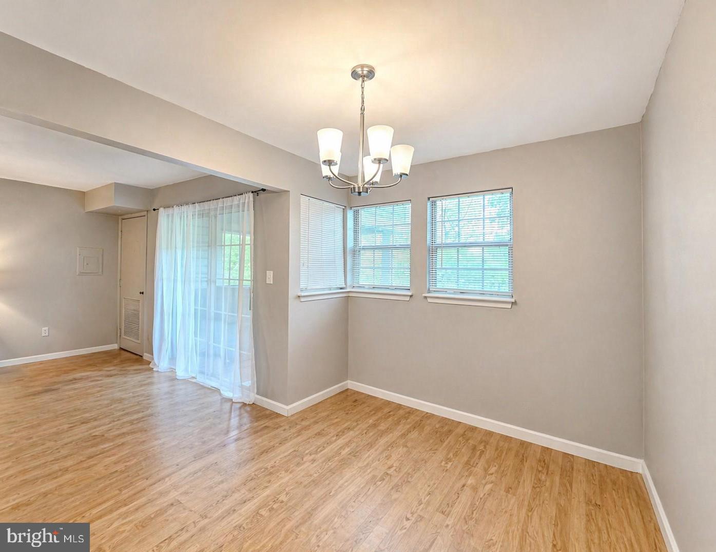 8353 Montgomery Run Road, Unit F Ellicott City, MD 21043 - Photo 12 of 25 wooden floor in an empty room with a window